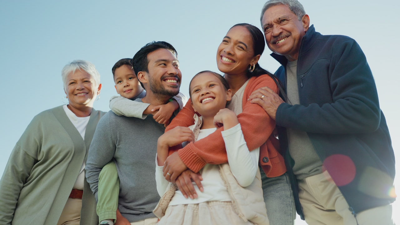 Three generations of a family smiling together, representing long-term health and reduced inflammation through lifestyle changes